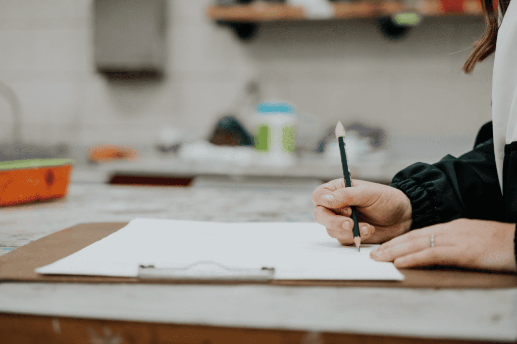 a student writing on a piece of paper